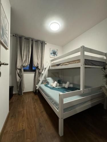 a bedroom with two bunk beds in a room at Villa Providenca in Poličnik