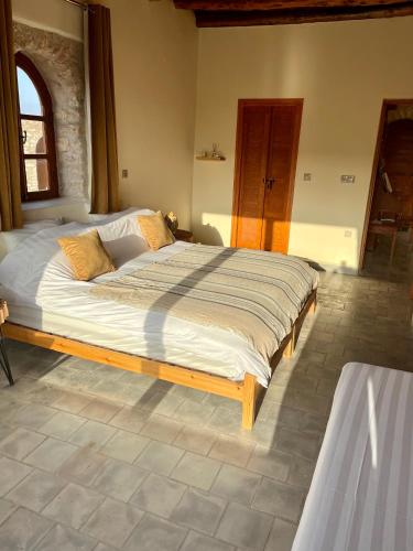 a bedroom with a large bed in a room at Villa'S in Zaouiet Bouzarktoune