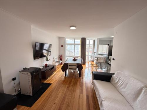 a living room with a white couch and a table at By The Ocean in Póvoa de Varzim