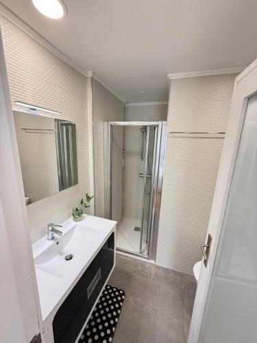 a bathroom with a sink and a shower at By The Ocean in Póvoa de Varzim