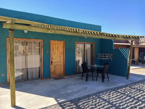 a building with a table and chairs in front of it at Cabañas Stommeln in Ovalle