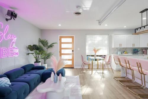 a living room with a blue couch and a kitchen at Chic pool home 6 mi to beach sleeps 8 in Long Beach