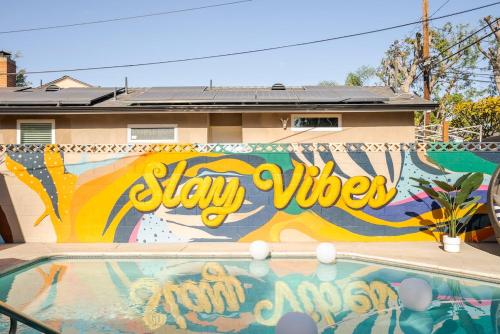 a mural on the side of a building with a swimming pool at Chic pool home 6 mi to beach sleeps 8 in Long Beach