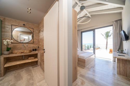 a bathroom with a sink and a mirror at Irena Stone Villas Kefalonia in Lourdhata