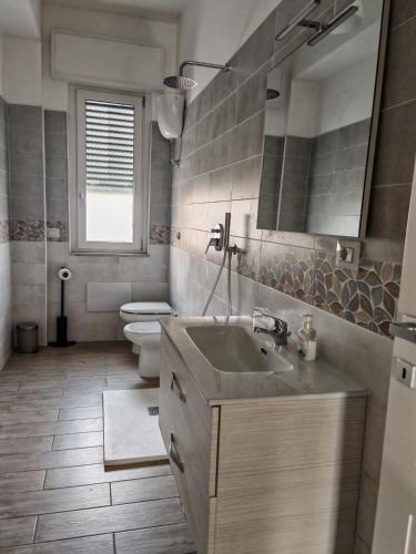 a bathroom with a sink and a toilet at Le Cavallerizze in Caserta