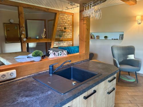 a kitchen with a sink and a mirror at Super Cozy Holiday Apartment in Steinfeld