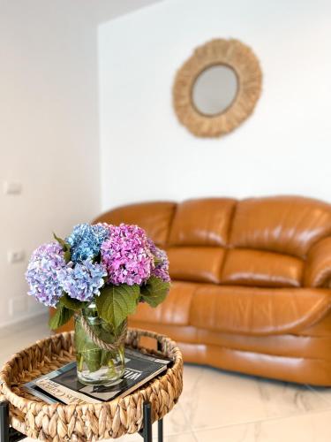 a vase of flowers on a table in a living room at CAPTAIN'S RESIDENCE in Ksamil