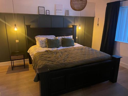 a bedroom with a bed with two pillows on it at An Teach Glas in Bunbeg