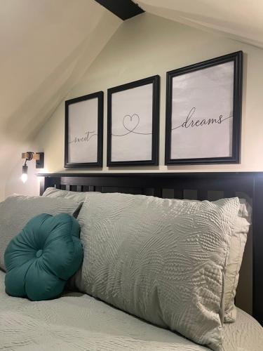 a bedroom with four pictures on the wall above a bed at An Teach Glas in Bunbeg