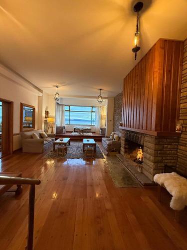 a living room with a fireplace and a couch at Del Lago Sky Hotel in San Carlos de Bariloche