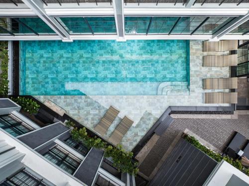 an overhead view of a pool in a building at Chateau Du Village Patong in Patong Beach