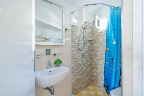 a bathroom with a sink and a shower at Villa De Luca - Luxury villa with terrace and Jacuzzi by the sea in Vico Equense