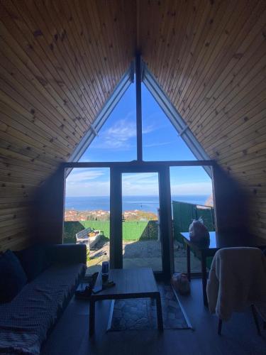 a large window in a room with a couch and a table at Amasra Miray Deniz Bungalow in Amasra