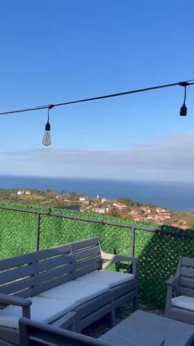 a bench on a balcony with a view of the ocean at Amasra Miray Deniz Bungalow in Amasra
