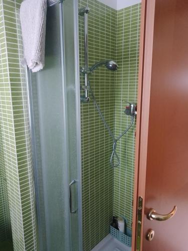 a bathroom with a shower with green tile at Octopus house in Civitanova Marche