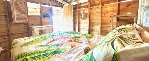 a bedroom with a bed in a wooden room at Buen Hombre Kite School with Accommodations in La Costa de Buen Hombre
