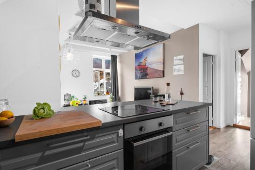 a kitchen with a sink and a stove at Big, family friendly apartment 6 min from the centrum in Bergen