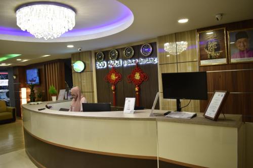 a hotel lobby with a reception desk and a tv at Xpeed Holiday Hotel in Kuala Lumpur
