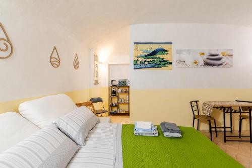a living room with a white couch and a table at Zen Studio in the Center With Free Parking and 24Hours Automatic Check-In in Casale Monferrato