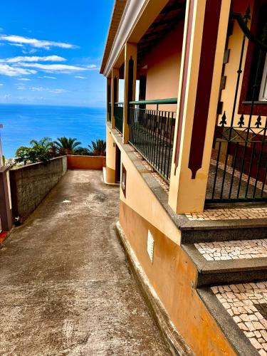 a balcony of a house with a view of the ocean at Villa Michelangelo in Câmara de Lobos