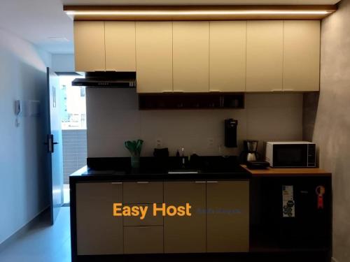 a kitchen with an easy host sign on the counter at Flats Tramonto - By EasyHost in João Pessoa