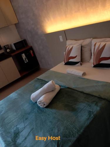 a bedroom with a bed with two towels on it at Flats Tramonto - By EasyHost in João Pessoa
