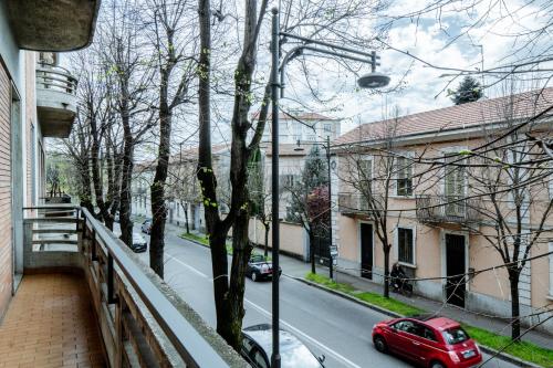 a red car parked on the street from a balcony at Luxe Apartment near Milano, Rho Fiera e MXP in Busto Arsizio