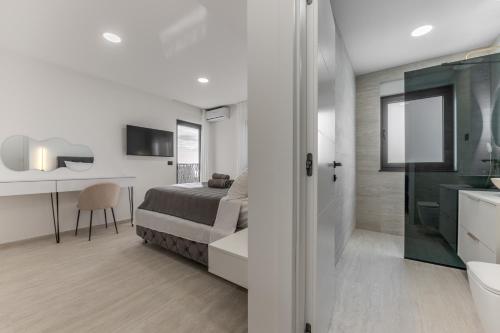 a bedroom with a bed and a bathroom at Villa Marta in Makarska
