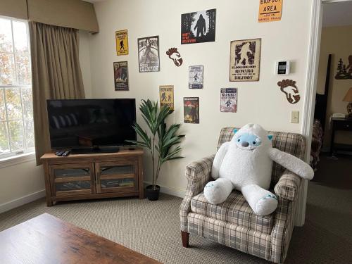 a living room with a teddy bear sitting in a chair at Unique Yeti-Theme Ski On Off Suite Jiminy-Sleeps 4 in Hancock