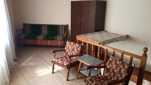 a room with two chairs and a crib and a chair at The Rock View in Petra