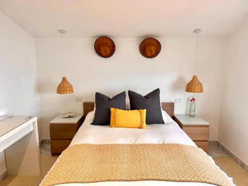 a bedroom with a bed with two night stands at Casa A Codela in Combarro