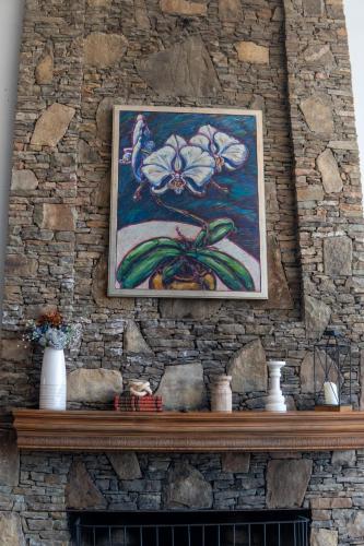 a painting of a flower on a stone wall at Inn at Crestwood in Boone
