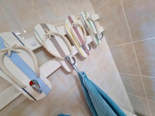 a towel rack with a pair of scissors on the wall of a bathroom at A La Plage in Leucate