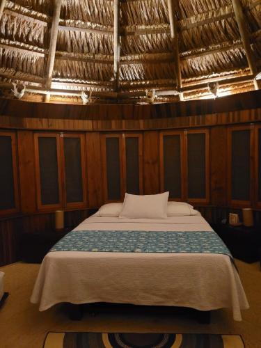 a bedroom with a large bed in a room at Ecohabs Tequendama - Parque Tayrona in El Zaino