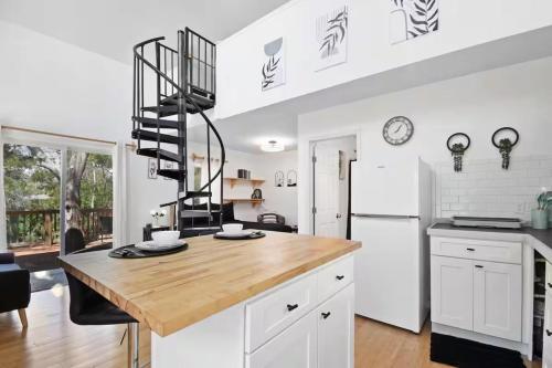 a kitchen with a wooden counter top and a white refrigerator at Anastasia Island Treehouse in St. Augustine