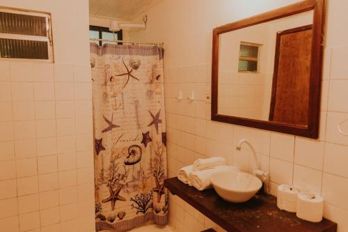 a bathroom with a sink and a mirror at POUSADA e BANGALOS VILA DA BARCA in Ilha de Boipeba