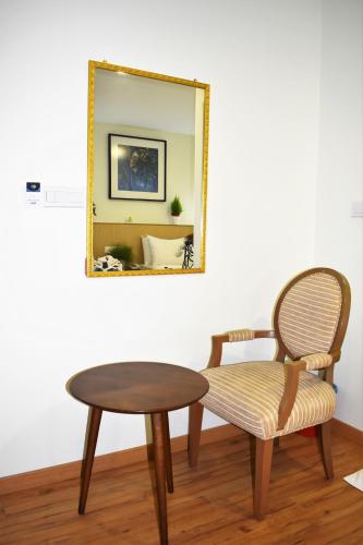 a table and a chair and a mirror at Xpeed Holiday Hotel in Kuala Lumpur
