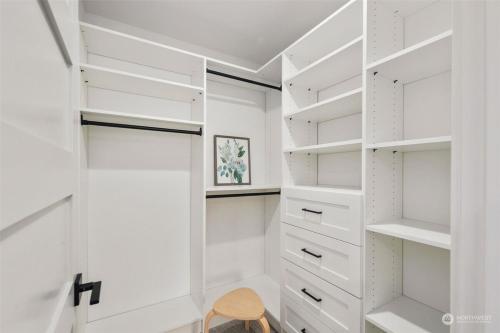 a white walk in closet with white shelves at Alki Beach Front TownHome in Seattle