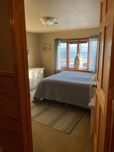 a bedroom with a bed and a window at The Smiling Bear Cabin in Two Rivers
