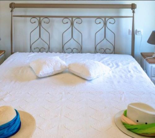 a bed with two pillows and a tray with a hat at Old Mansion Residence in Riglia