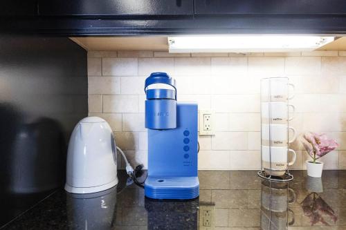 a blue and white blender sitting on a counter at Sky-Rise Apartments in Los Angeles