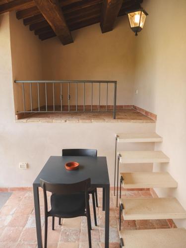 a dining room with a table and chairs and stairs at Agriturismo Camponovo in Brisighella