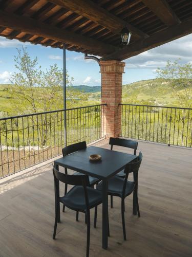 a table and chairs on a porch with a view at Agriturismo Camponovo in Brisighella