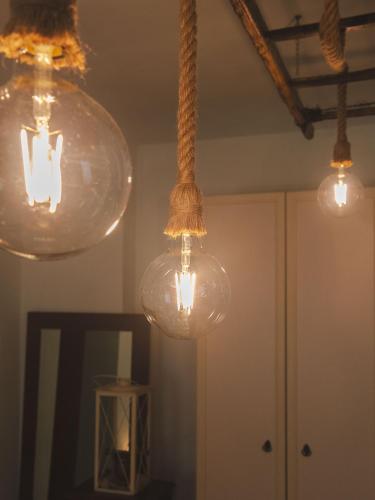 a group of lights hanging from a ceiling at Agriturismo Camponovo in Brisighella