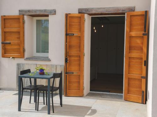 a table and chairs in front of a door at Agriturismo Camponovo in Brisighella