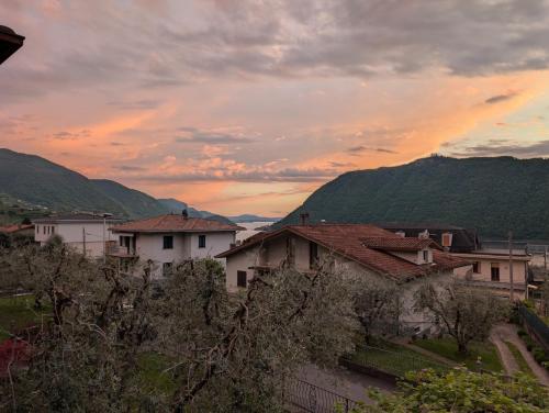 a group of houses on a hill with a sunset at Iseo Lake Terrace in Sale Marasino