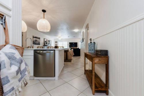 a kitchen with a sink and a dishwasher at Catch the Breeze on Crystal Beach in Palm Harbor