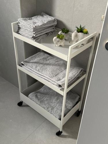 a white shelf with towels and towels on it at Brandnew Rooftop Flat near Larnaca Mall in Larnaca