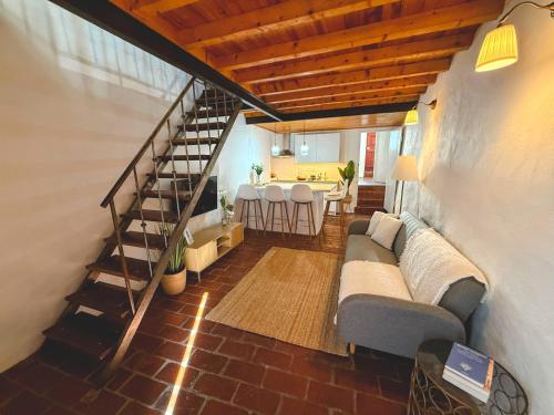 a living room with a couch and a staircase at Casa "A Sobreira" in Portel