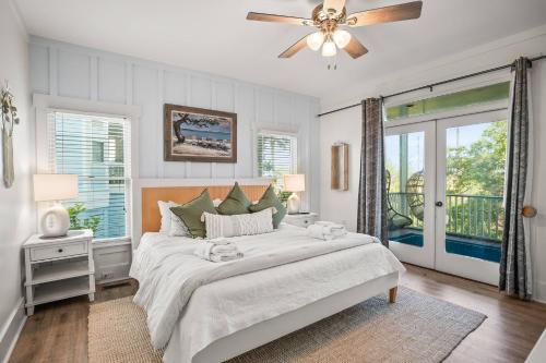 a white bedroom with a bed and a ceiling fan at Fripp Island 94 Davis Love Dr in Fripp Island